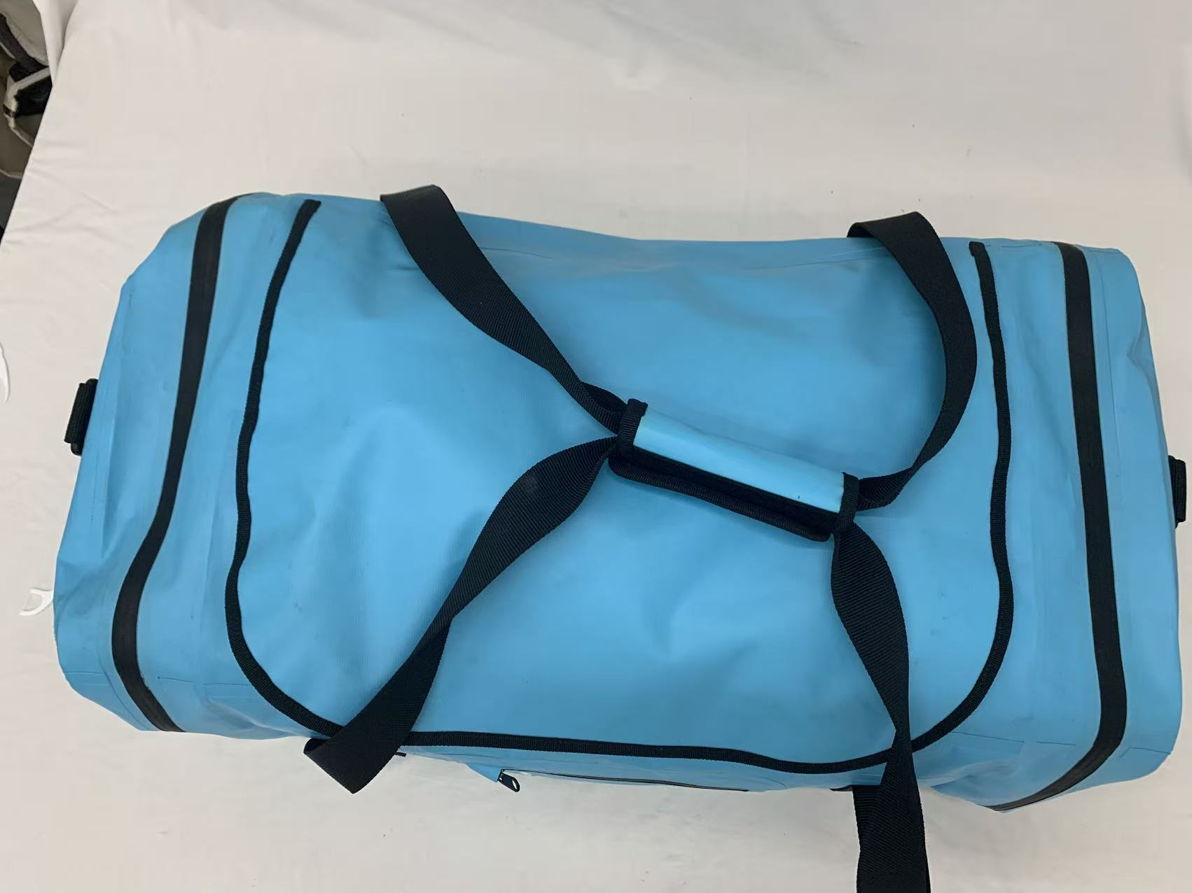  reinforced webbing handles and shoulder strap on waterproof duffel